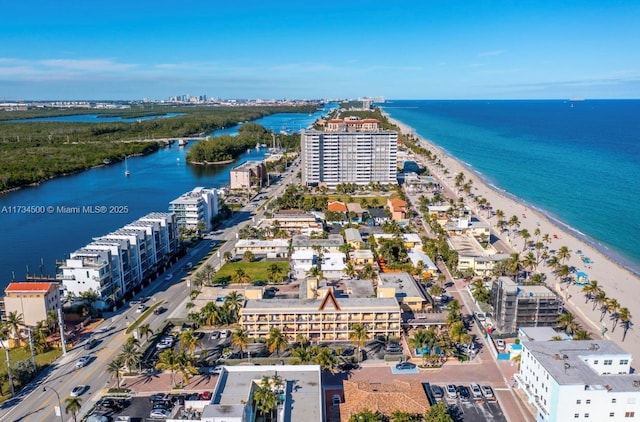 drone / aerial view featuring a water view and a beach view