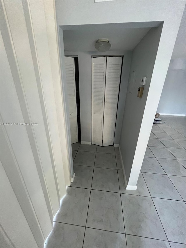 hall with light tile patterned flooring