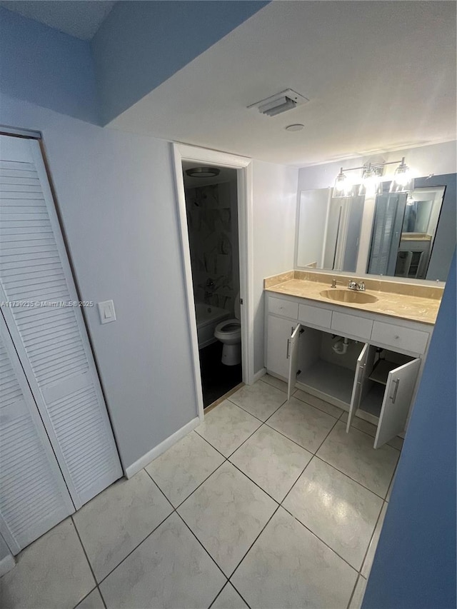 bathroom with tile patterned floors, vanity, and toilet