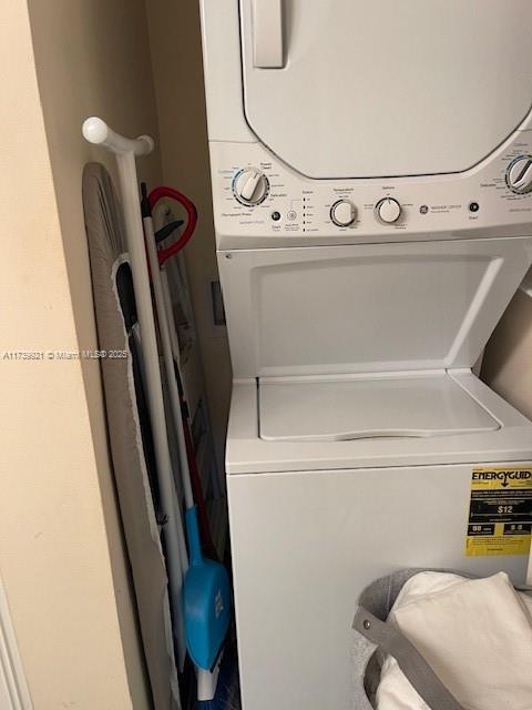 clothes washing area with stacked washer and dryer