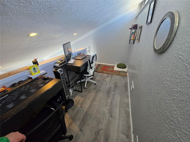 office area with wood-type flooring, ornamental molding, and a textured ceiling