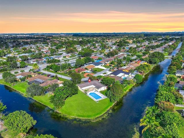 aerial view at dusk with a water view