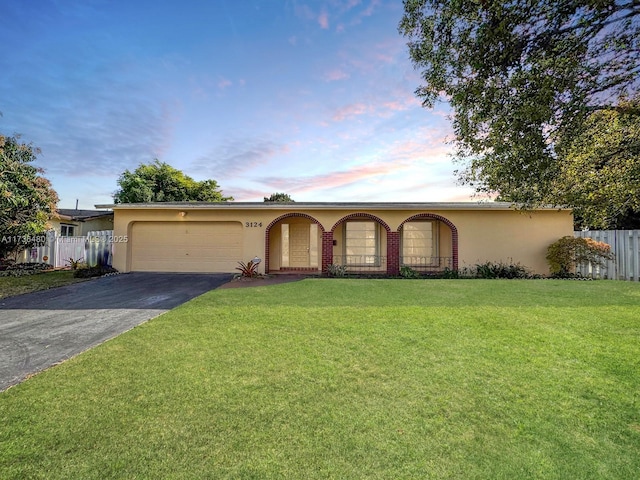 ranch-style house featuring a lawn