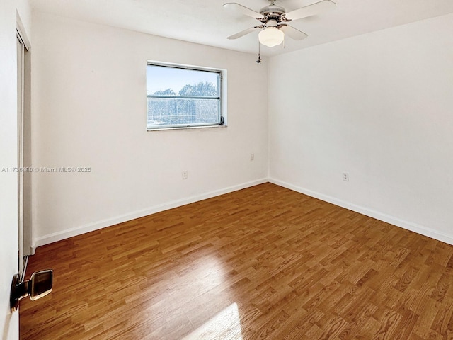 empty room featuring wood-type flooring and ceiling fan