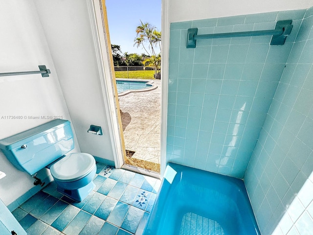 bathroom featuring toilet and tile patterned flooring