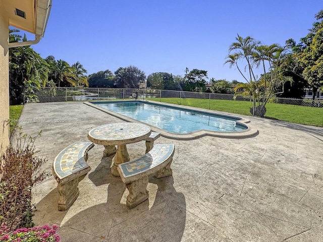 view of pool with a yard and a patio