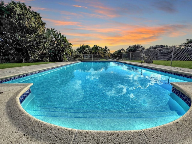 view of pool at dusk