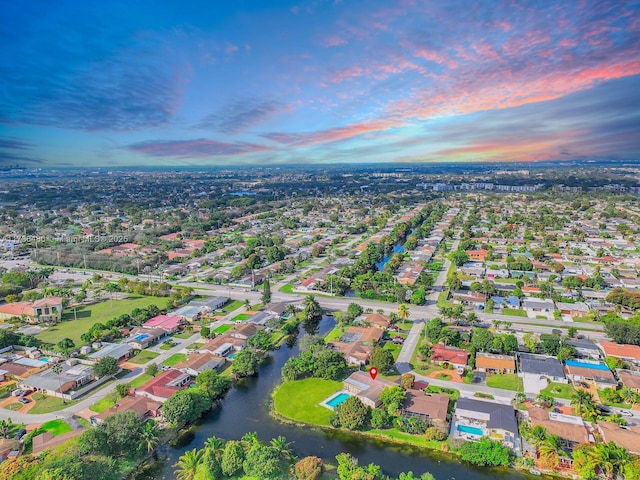 aerial view at dusk with a water view