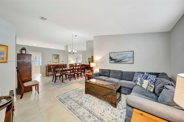 tiled living room with lofted ceiling and a notable chandelier