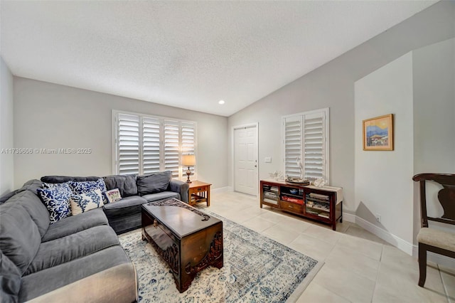 tiled living room featuring vaulted ceiling and a textured ceiling