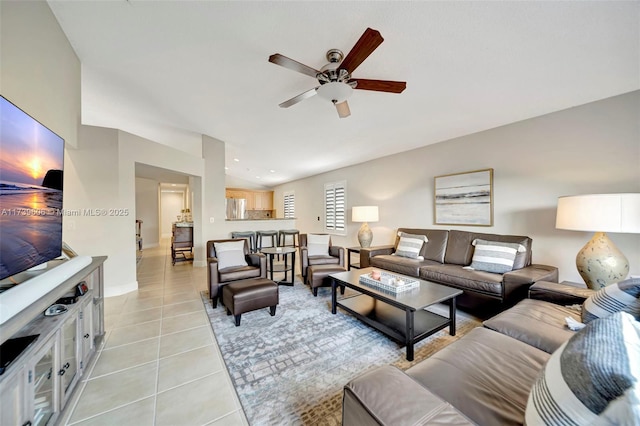 tiled living room with lofted ceiling and ceiling fan