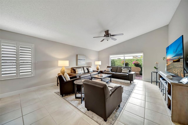 tiled living room featuring a textured ceiling, vaulted ceiling, and ceiling fan