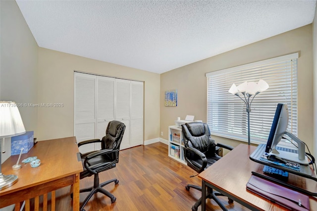 office area featuring wood-type flooring and a textured ceiling