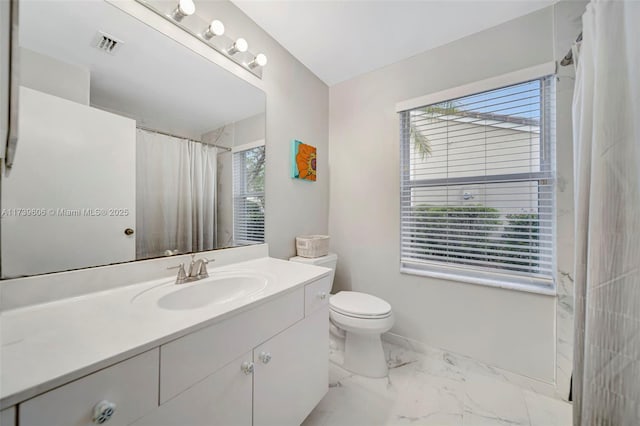 bathroom featuring vanity, walk in shower, and toilet