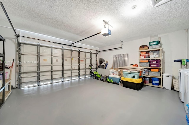 garage featuring a garage door opener and washer / clothes dryer