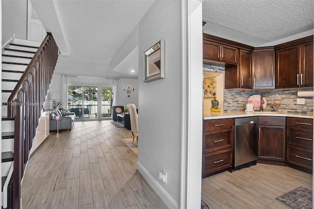 kitchen with tasteful backsplash, stainless steel dishwasher, dark brown cabinets, and light wood-type flooring