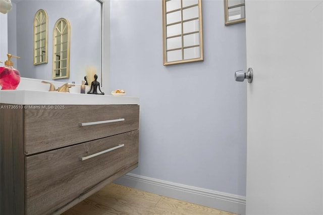 bathroom with hardwood / wood-style flooring and vanity