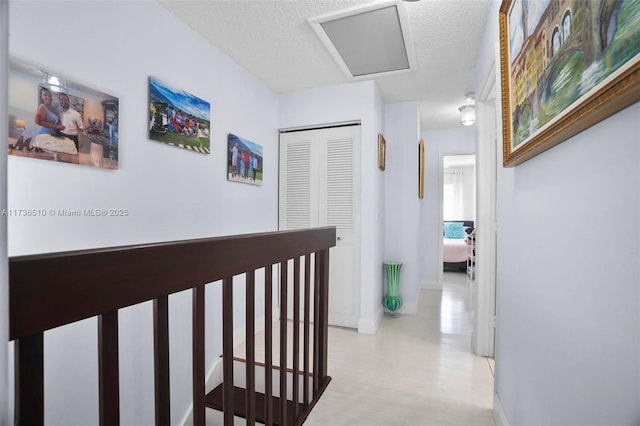 hall featuring a textured ceiling