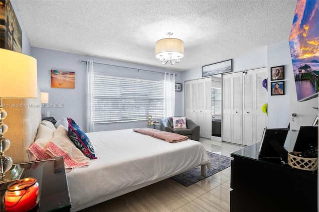 bedroom featuring a chandelier and a textured ceiling