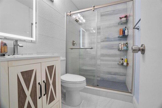 bathroom featuring walk in shower, vanity, toilet, and tile walls