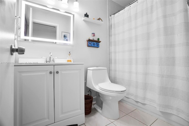 full bathroom featuring shower / bath combination with curtain, vanity, tile patterned floors, and toilet