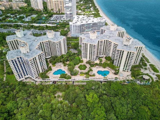 aerial view with a water view and a beach view