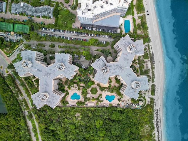 drone / aerial view featuring a water view and a view of the beach