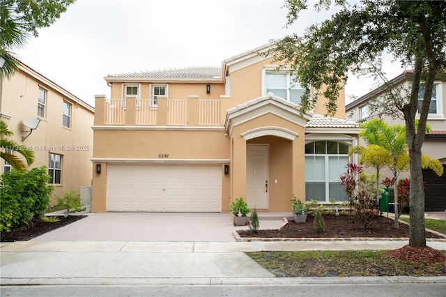 view of front of house with a garage and a balcony