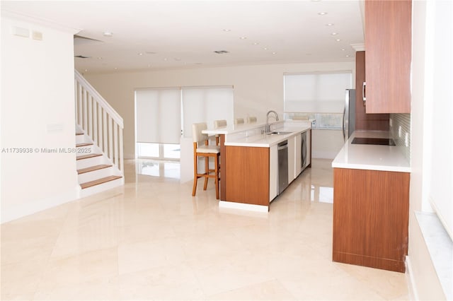 kitchen featuring sink, crown molding, appliances with stainless steel finishes, washer / clothes dryer, and backsplash