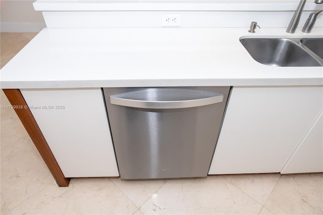 kitchen with sink, stainless steel dishwasher, and white cabinets