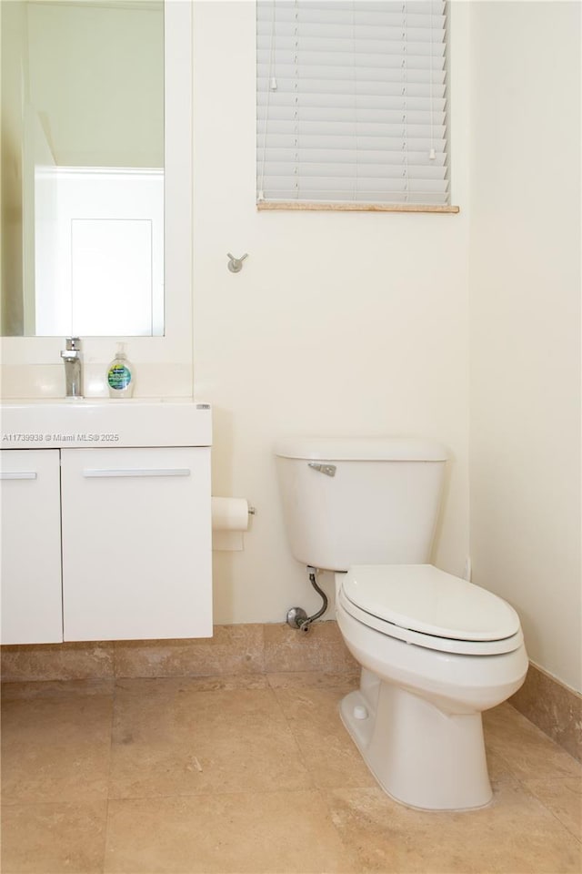 bathroom with tile patterned flooring, vanity, and toilet