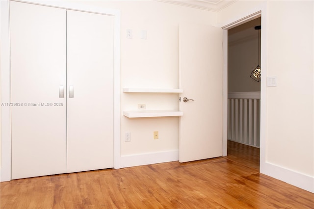 unfurnished bedroom featuring light hardwood / wood-style floors and a closet