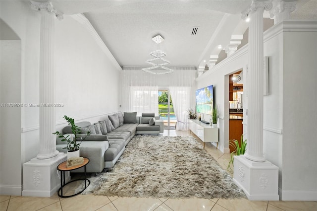 living room featuring ornate columns, crown molding, and light tile patterned floors