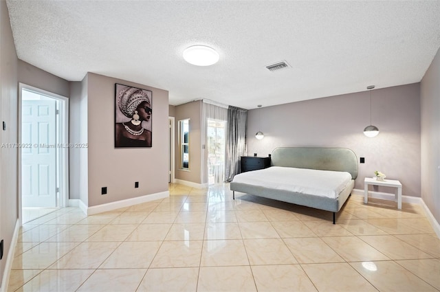 tiled bedroom featuring a textured ceiling