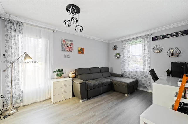 living room with a textured ceiling, ornamental molding, hardwood / wood-style flooring, and plenty of natural light