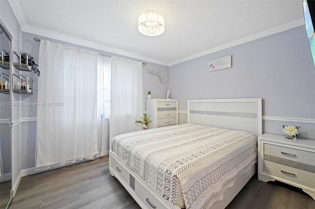 bedroom with ornamental molding and hardwood / wood-style flooring