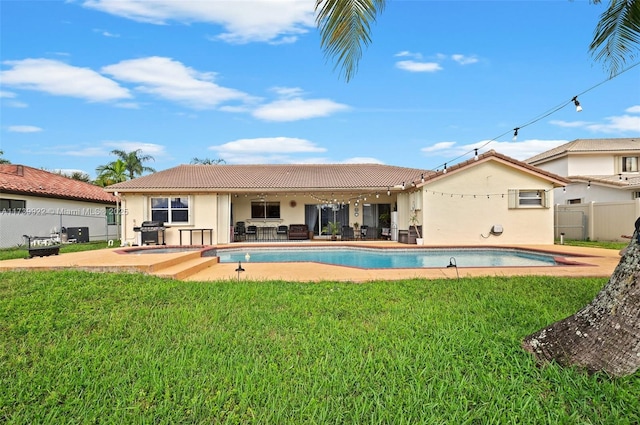 rear view of property with a lawn and a patio area