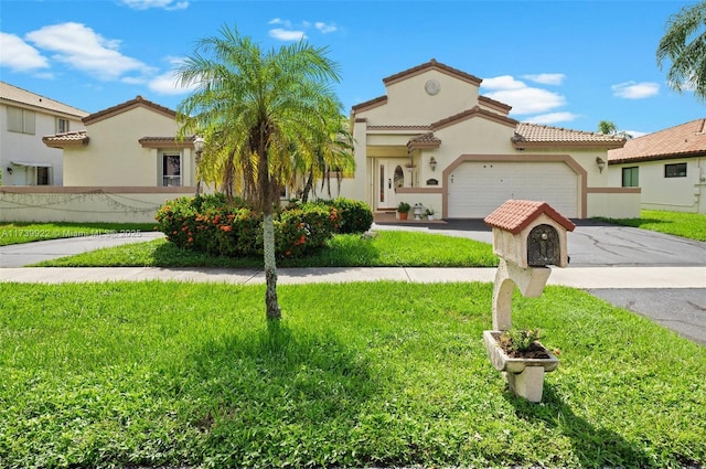 mediterranean / spanish house featuring a front yard and a garage