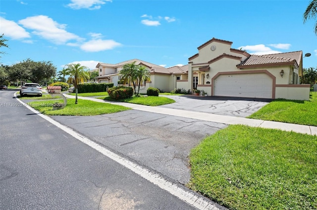 view of front of home featuring a front lawn and a garage