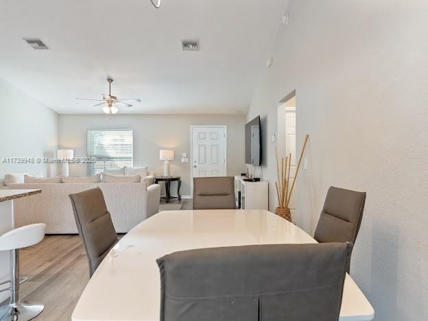 dining room with ceiling fan and light hardwood / wood-style flooring