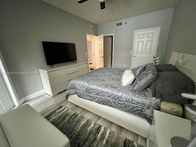 bedroom with light hardwood / wood-style floors and ceiling fan