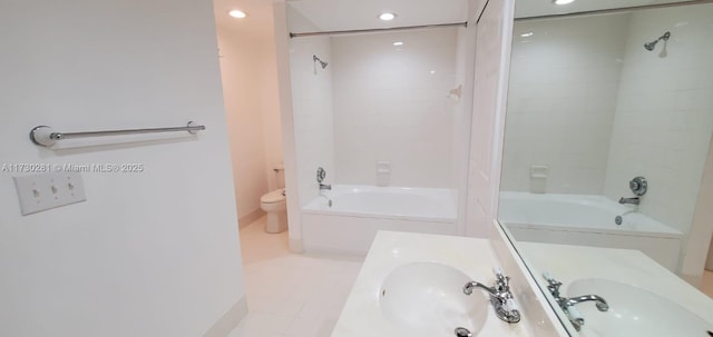 full bathroom with vanity, tiled shower / bath combo, tile patterned floors, and toilet