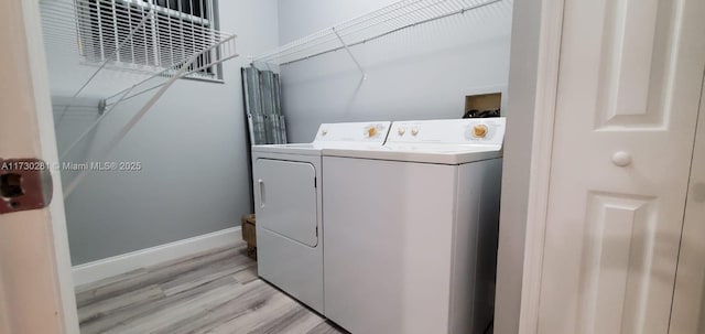 laundry room featuring independent washer and dryer and light hardwood / wood-style floors