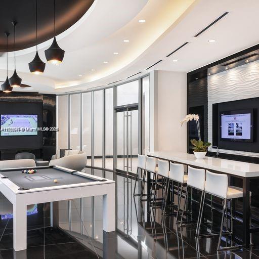 851 NE 1st Ave Unit 3303, Miami, FL 33132 - playroom featuring a tray ceiling, a wall of windows, and pool table