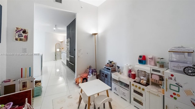 851 NE 1st Ave Unit 3303, Miami, FL 33132 - kitchen with light tile patterned floors and white cabinets
