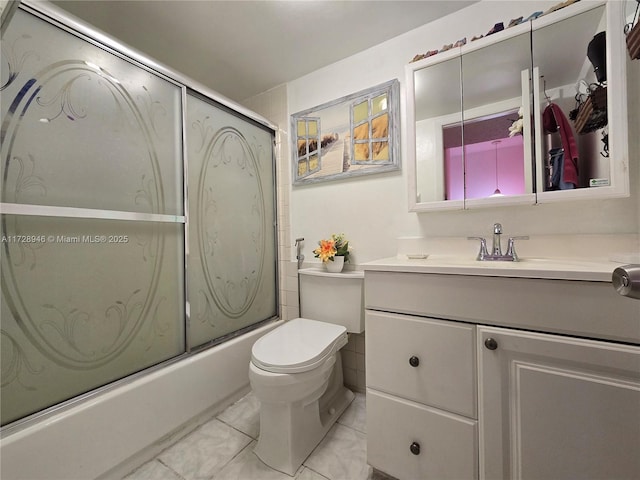 full bathroom with vanity, bath / shower combo with glass door, and toilet