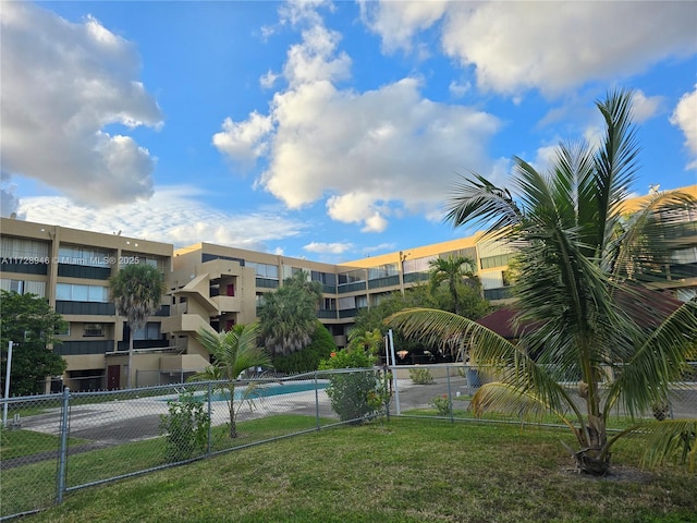 view of pool featuring a lawn