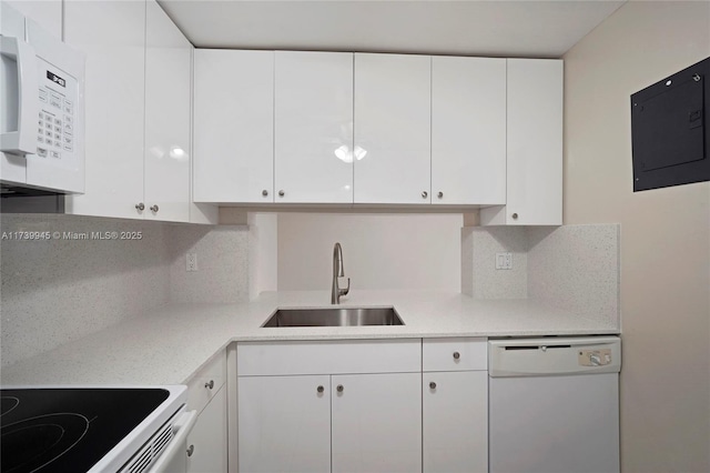 kitchen with white cabinetry, white appliances, electric panel, and sink