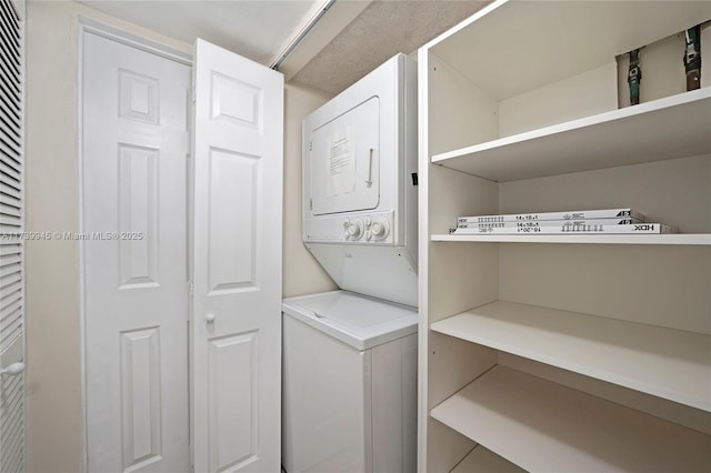 laundry room with stacked washer / dryer