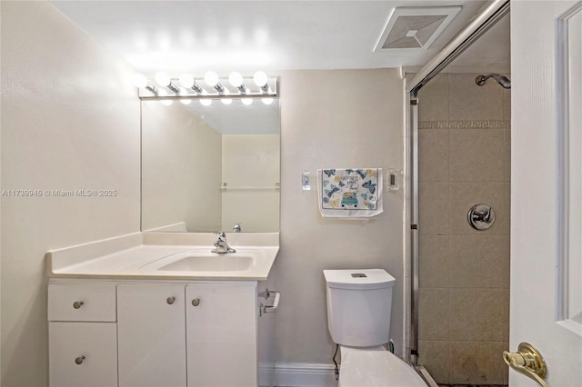 bathroom featuring vanity, toilet, and an enclosed shower